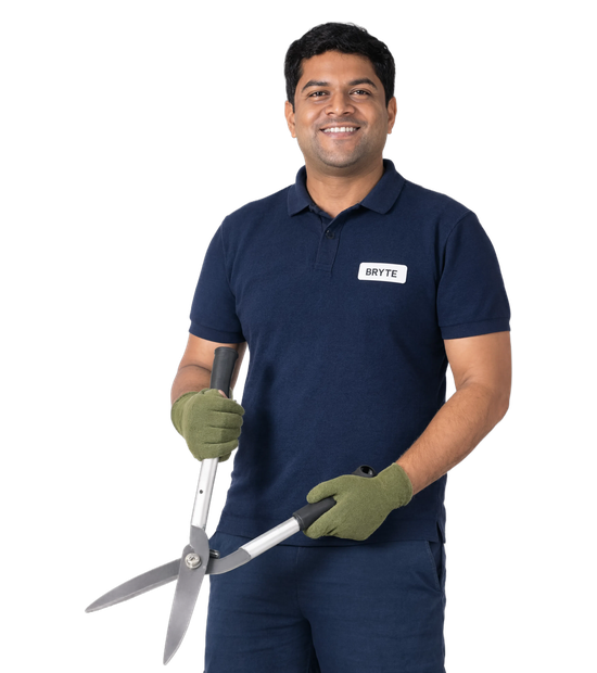 Bryte landscaping and external area maintenance worker in navy uniform holding hedge shears